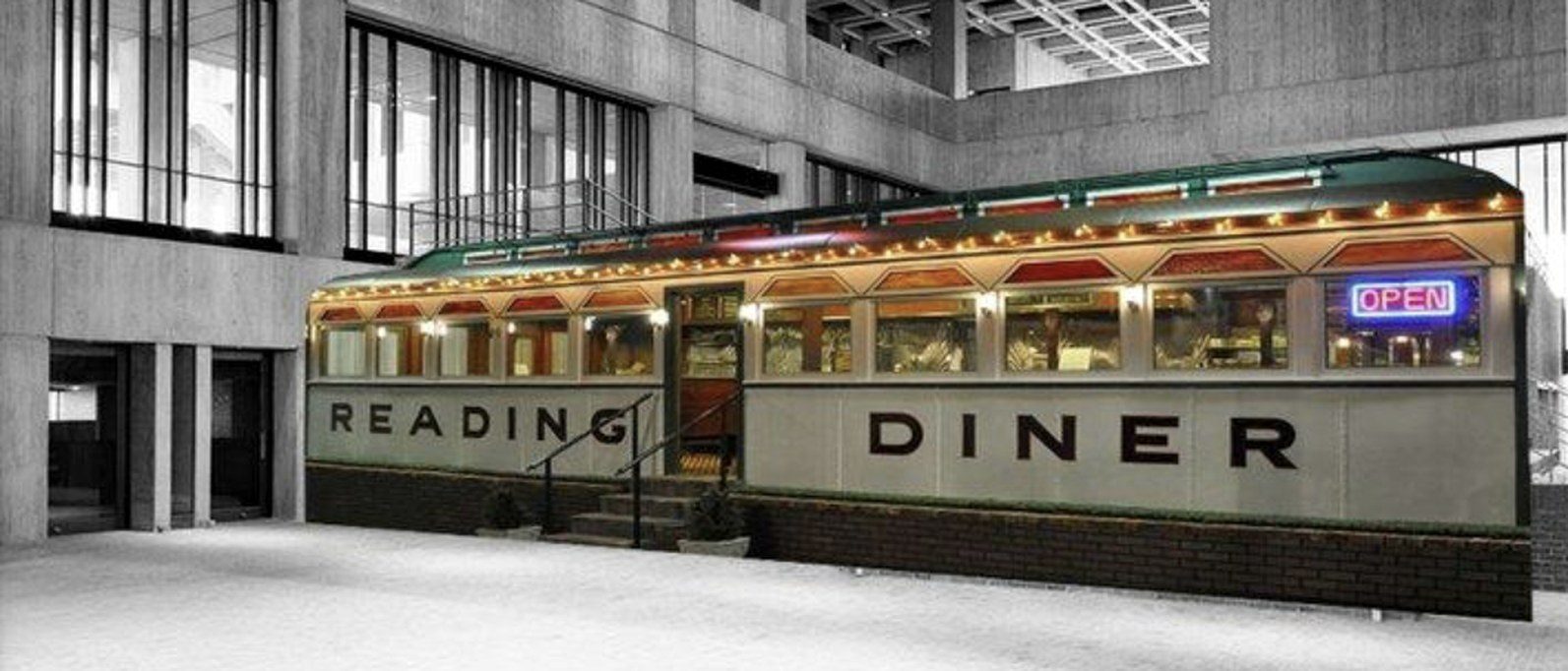 a classic diner car glowing inside a concrete atrium