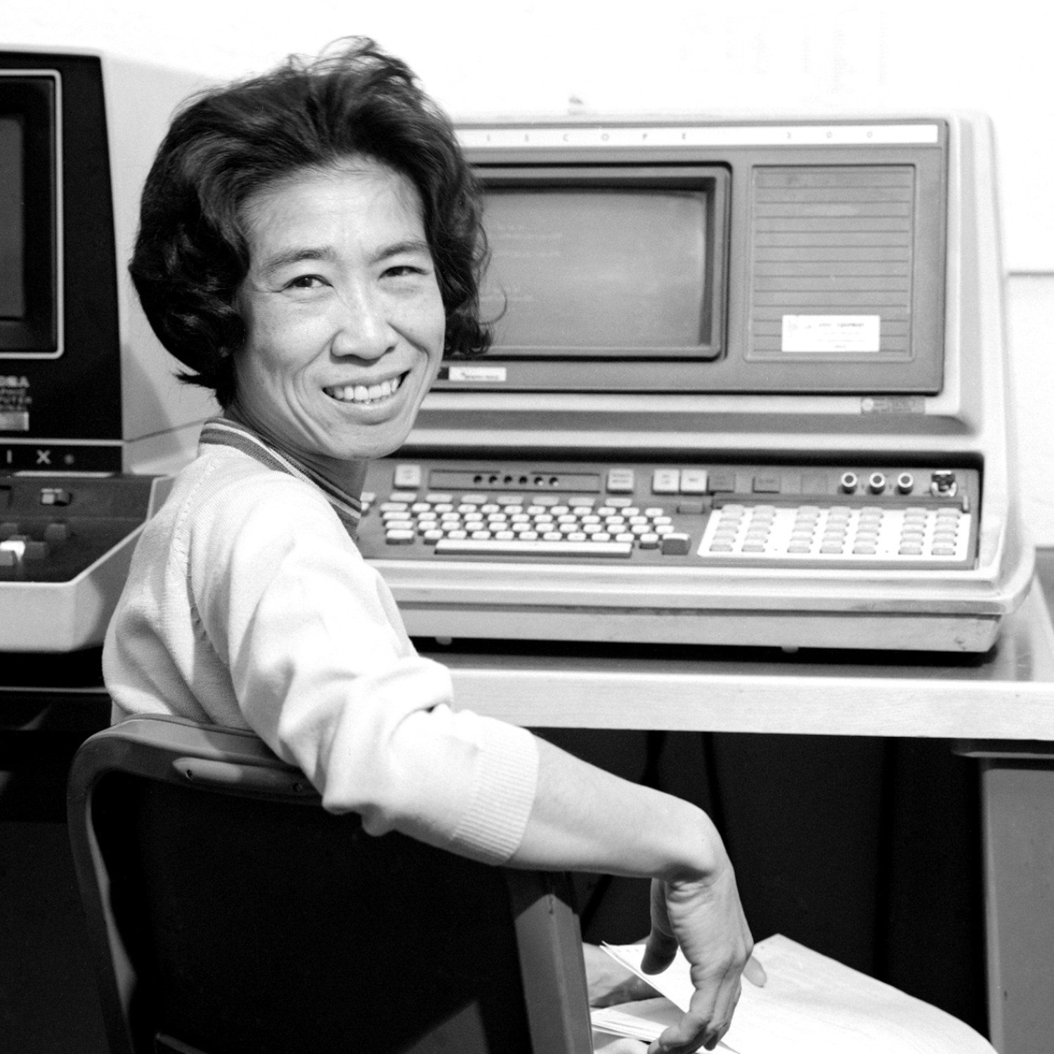josephine jue smiling at her computer terminal