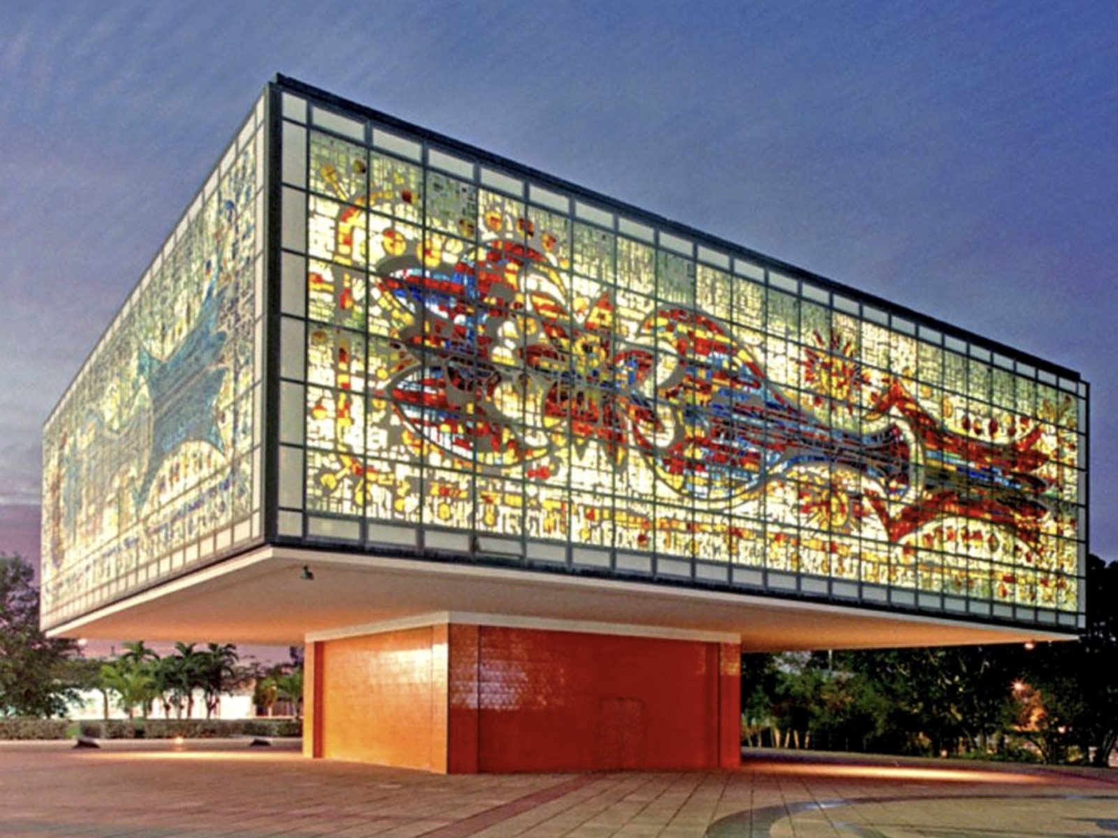 the bacardi jewel box building in miami, its glass mosaic walls lit at dusk