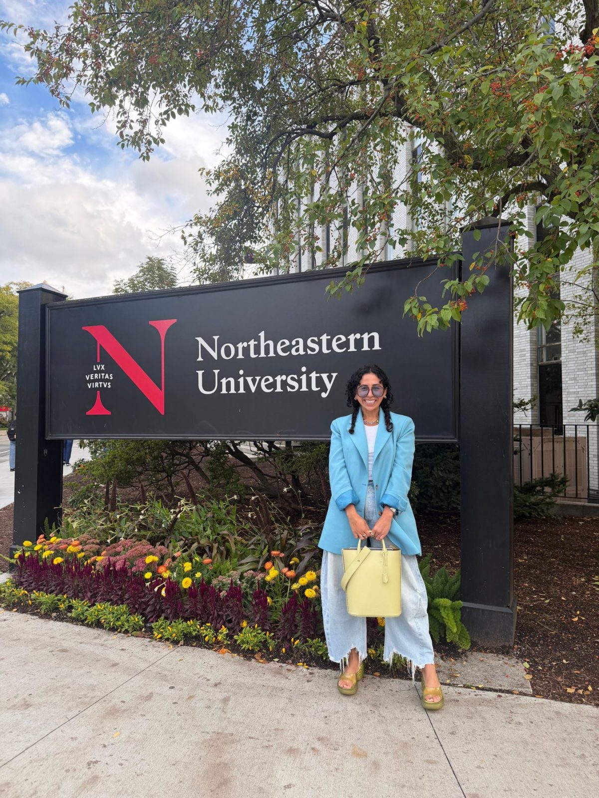 hailey in front of the northeastern university sign after speaking at northeastern law