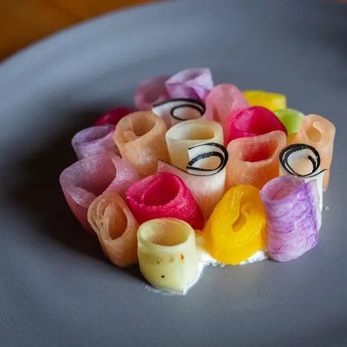 a plated dish of colorful rolled vegetables