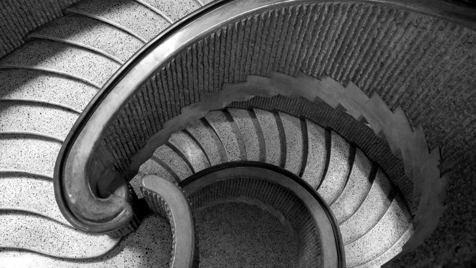a spiral terrazzo staircase seen from above
