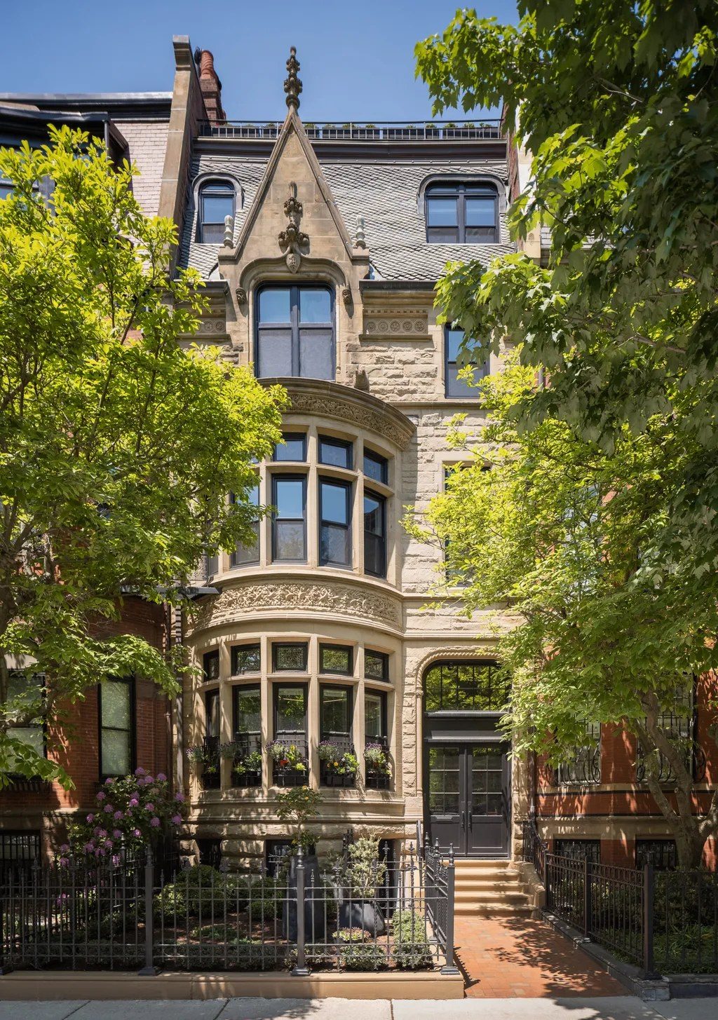 a restored stone townhouse with bay windows